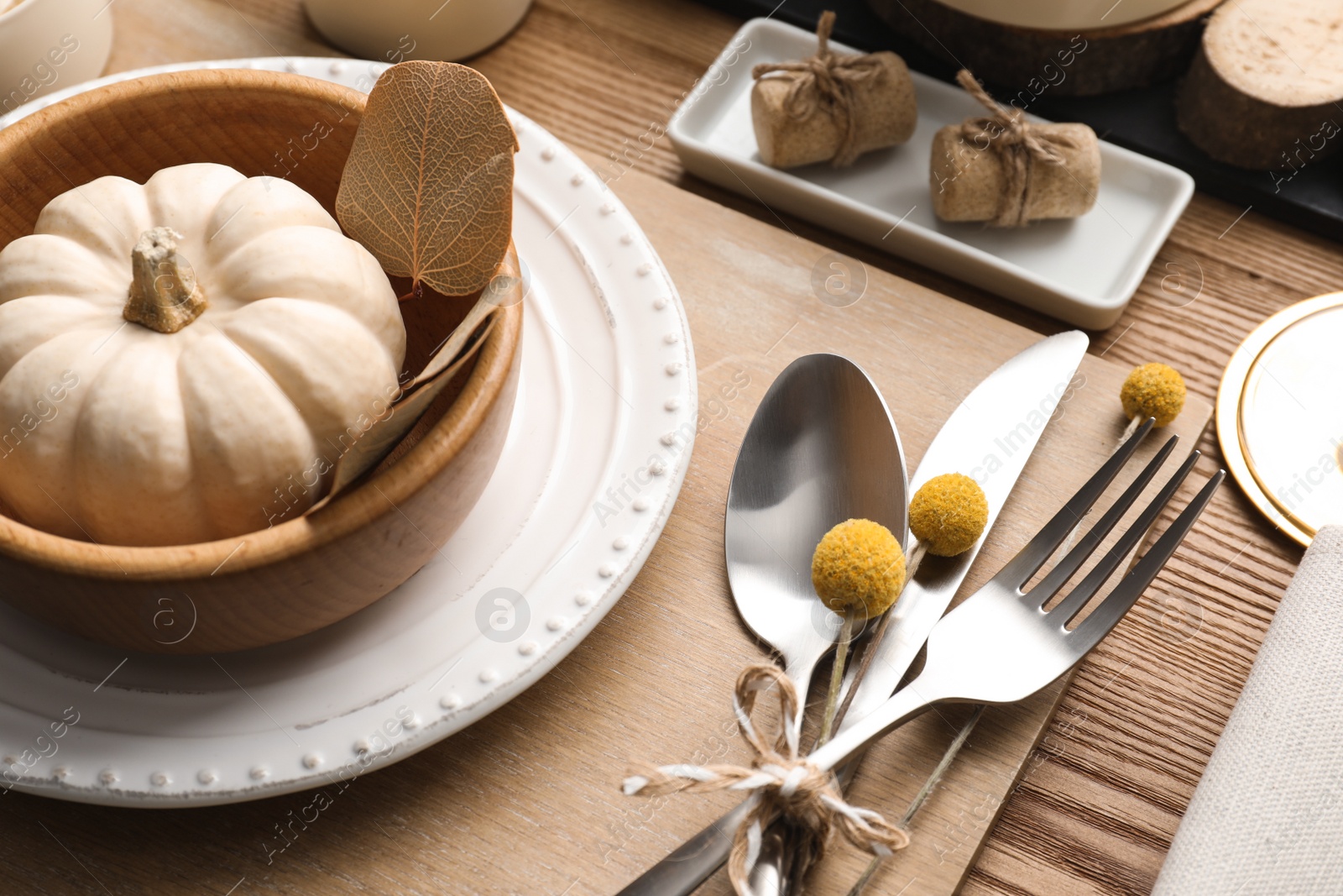 Photo of Autumn table setting with pumpkin and decor on wooden background