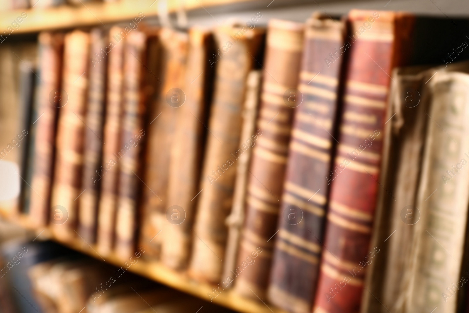 Blurred view of old books on shelf in library Photo of Blurred view of old books on shelf in library