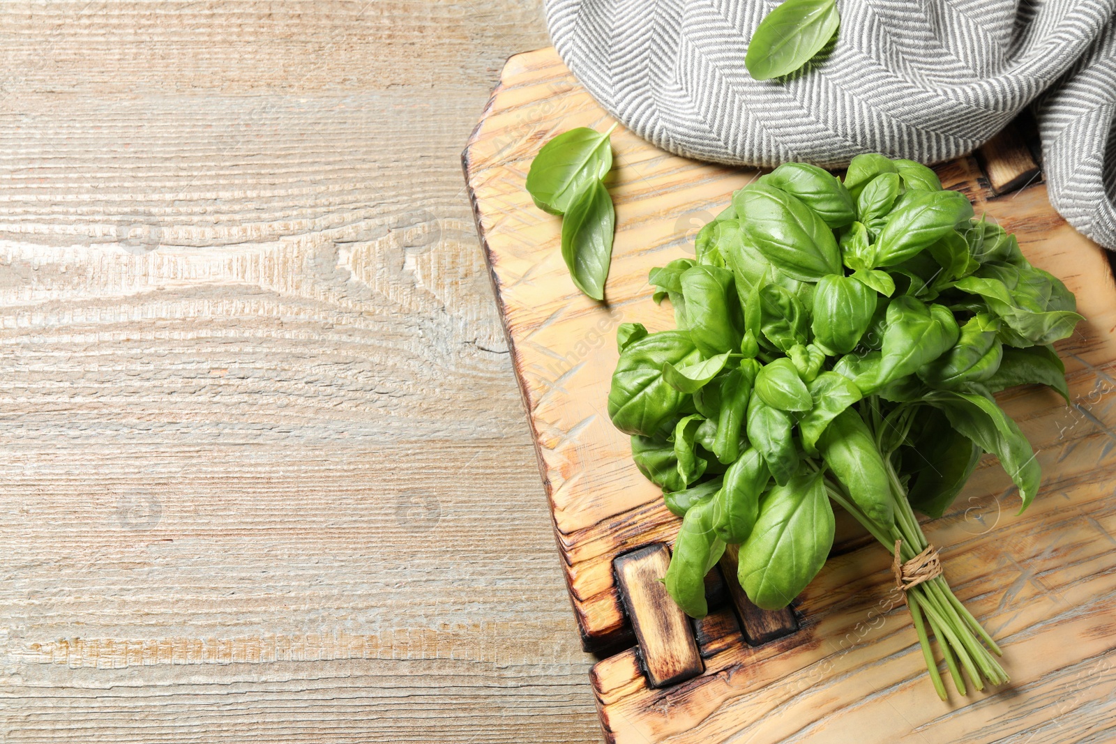 Fresh basil on wooden table, top view. Space for text Photo of Fresh basil on wooden table, top view. Space for text