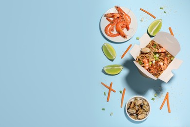 Flat lay composition with noodle wok and ingredients on light blue background. Space for text Photo of Flat lay composition with noodle wok and ingredients on light blue background. Space for text