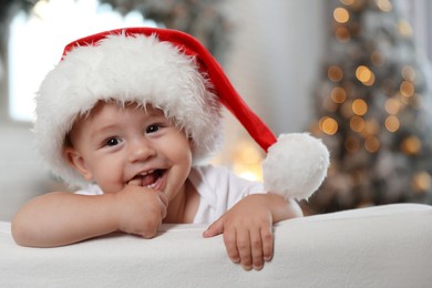 Cute little baby wearing Santa hat at home. Christmas celebration Image of Cute little baby wearing Santa hat at home. Christmas celebration