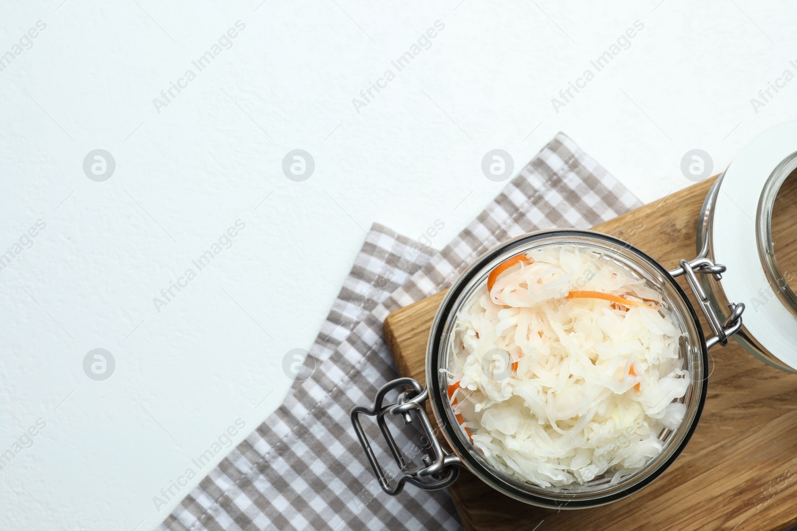 Tasty fermented cabbage on white table, top view. Space for text Photo of Tasty fermented cabbage on white table, top view. Space for text