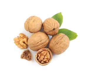 Pile of ripe walnuts and leaves on white background, top view Photo of Pile of ripe walnuts and leaves on white background, top view