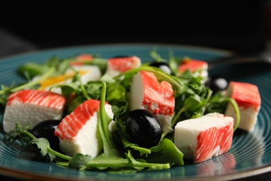 Delicious crab stick salad on blue plate, closeup Photo of Delicious crab stick salad on blue plate, closeup