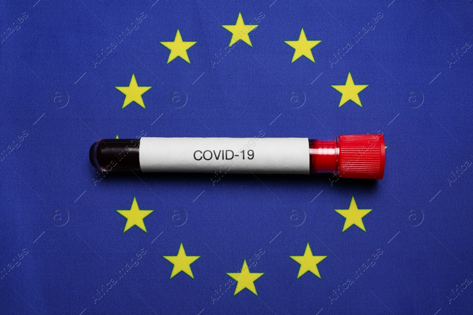 Test tube with blood sample on European Union flag background, top view. Coronavirus outbreak Photo of Test tube with blood sample on European Union flag background, top view. Coronavirus outbreak