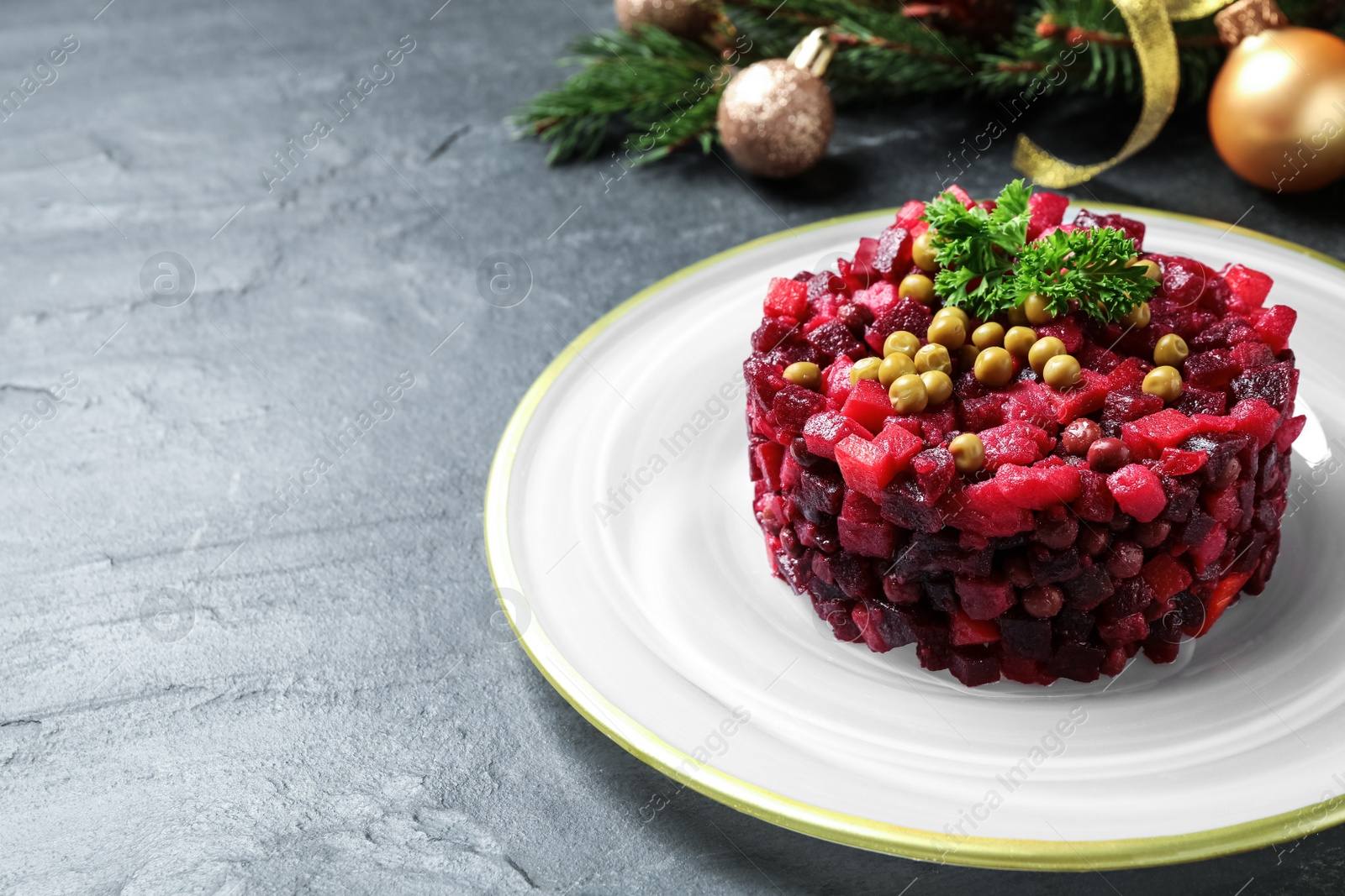 Traditional Russian salad vinaigrette on grey table, closeup. Space for text Photo of Traditional Russian salad vinaigrette on grey table, closeup. Space for text
