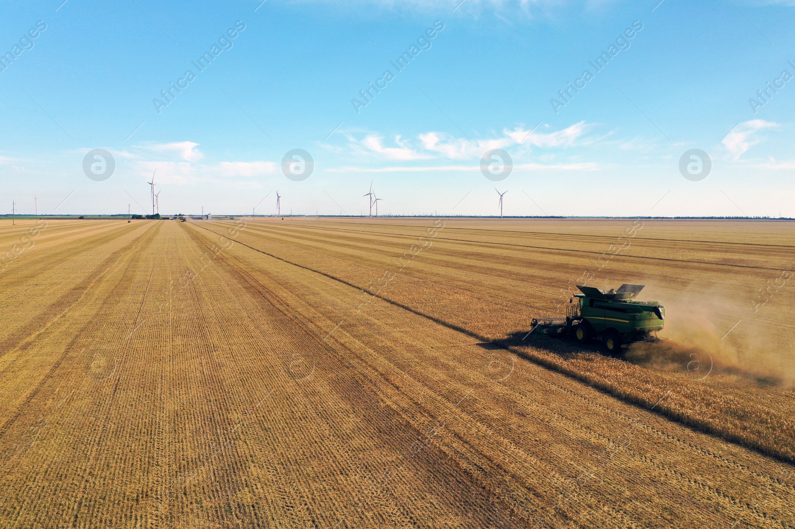 Modern combine harvester working in field on sunny day. Agriculture industry Photo of Modern combine harvester working in field on sunny day. Agriculture industry