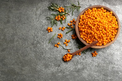Fresh ripe sea buckthorn on grey table, flat lay. Space for text Photo of Fresh ripe sea buckthorn on grey table, flat lay. Space for text
