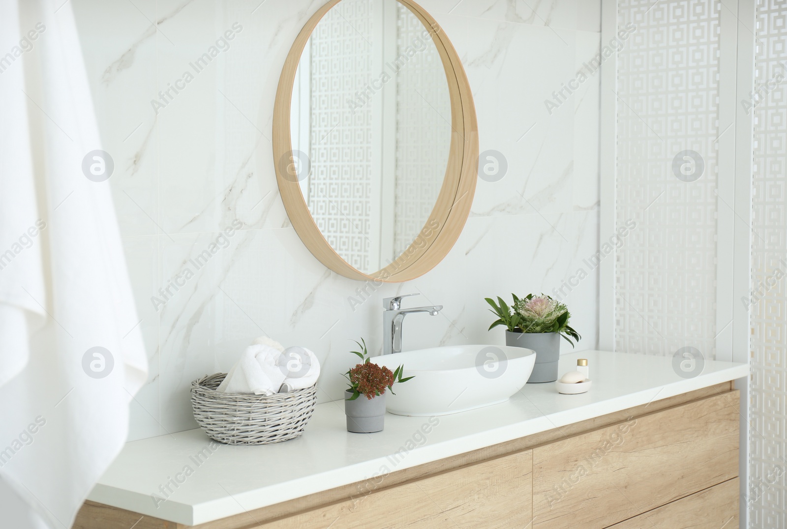 Modern bathroom interior with stylish mirror and vessel sink Photo of Modern bathroom interior with stylish mirror and vessel sink