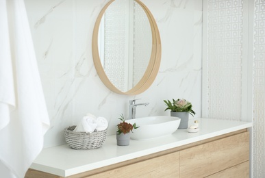 Modern bathroom interior with stylish mirror and vessel sink Photo of Modern bathroom interior with stylish mirror and vessel sink