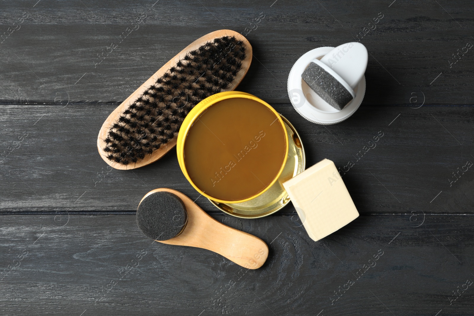 Flat lay composition with shoe care accessories on black wooden background Photo of Flat lay composition with shoe care accessories on black wooden background