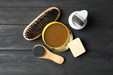 Flat lay composition with shoe care accessories on black wooden background Photo of Flat lay composition with shoe care accessories on black wooden background