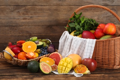 Assortment of fresh exotic fruits on wooden table Photo of Assortment of fresh exotic fruits on wooden table