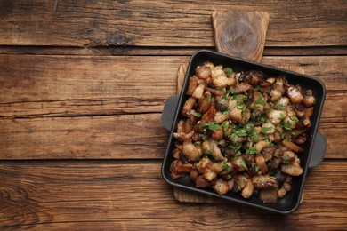 Tasty fried cracklings on wooden table, top view with space for text. Cooked pork lard Photo of Tasty fried cracklings on wooden table, top view with space for text. Cooked pork lard