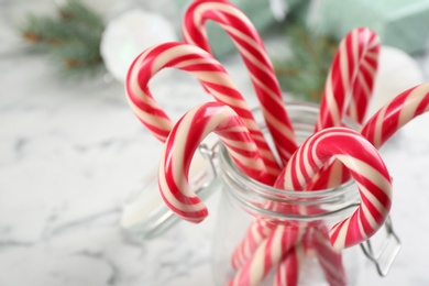Sweet Christmas candy canes in glass jar, closeup Photo of Sweet Christmas candy canes in glass jar, closeup