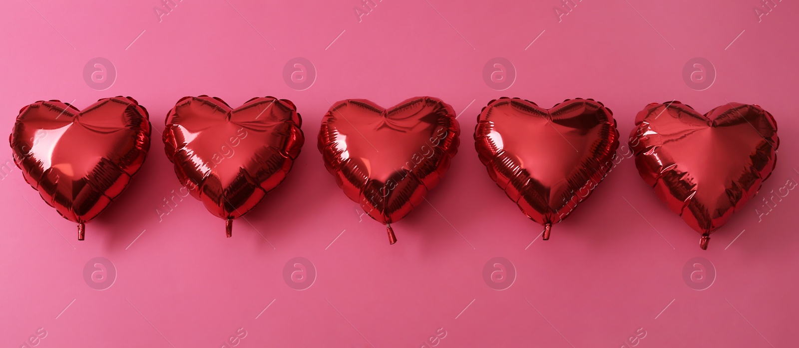 Red heart shaped balloons on pink background, flat lay. Saint Valentine's day celebration Photo of Red heart shaped balloons on pink background, flat lay. Saint Valentine's day celebration