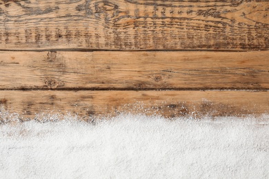 Artificial snow on wooden background, top view with space for text. Christmas decor Photo of Artificial snow on wooden background, top view with space for text. Christmas decor