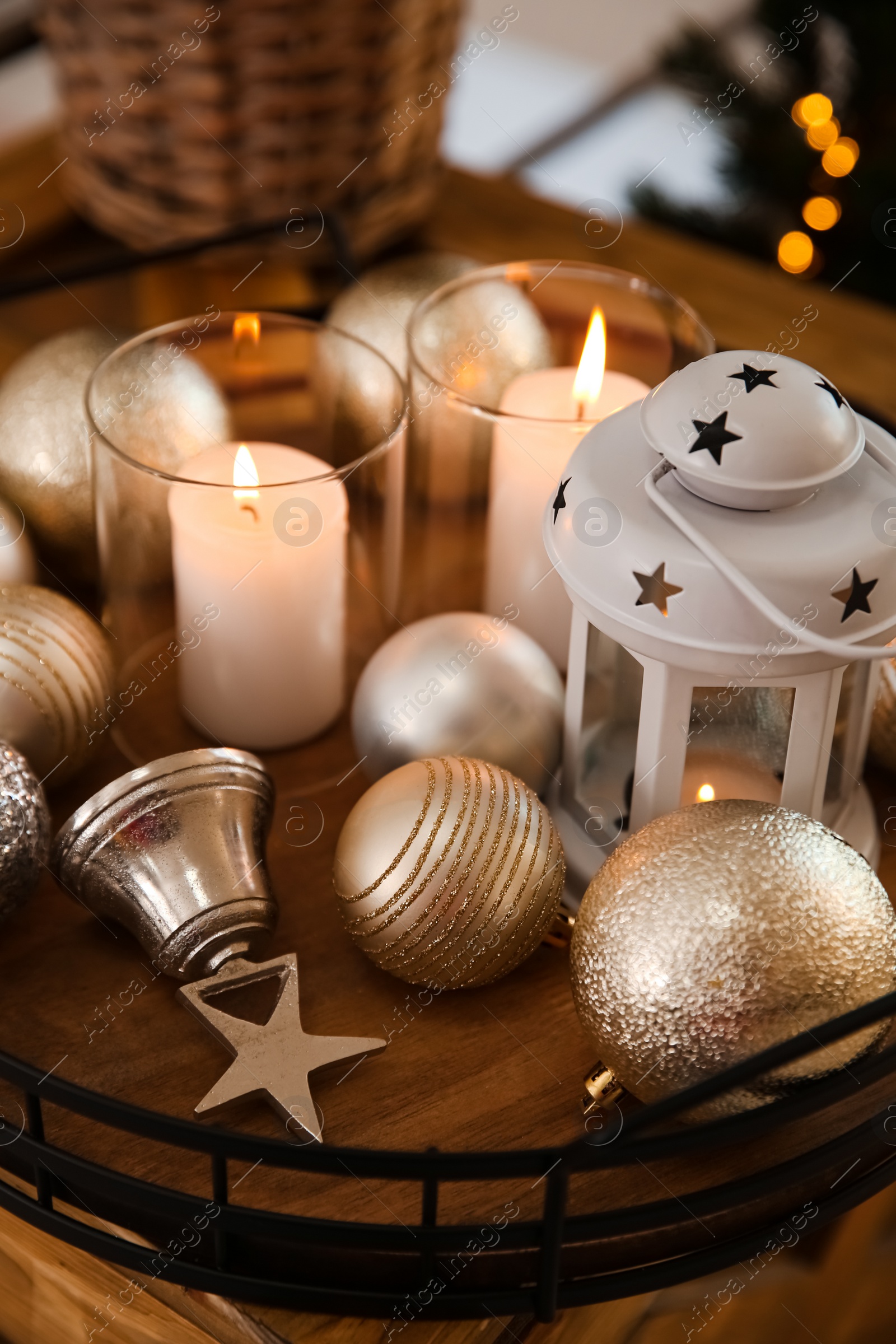 Burning candles, lantern and Christmas balls on wooden table indoors, closeup Photo of Burning candles, lantern and Christmas balls on wooden table indoors, closeup