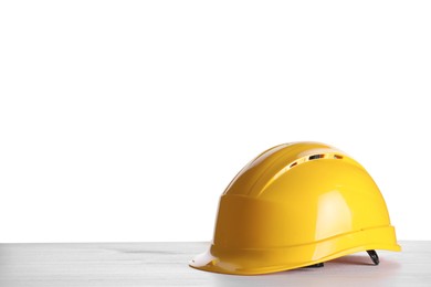Yellow hard hat on wooden table against white background. Space for text Photo of Yellow hard hat on wooden table against white background. Space for text