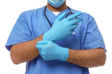 Doctor putting on medical gloves against white background, closeup Photo of Doctor putting on medical gloves against white background, closeup
