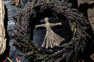 Female voodoo doll surrounded by ceremonial items on black wooden background, flat lay Photo of Female voodoo doll surrounded by ceremonial items on black wooden background, flat lay