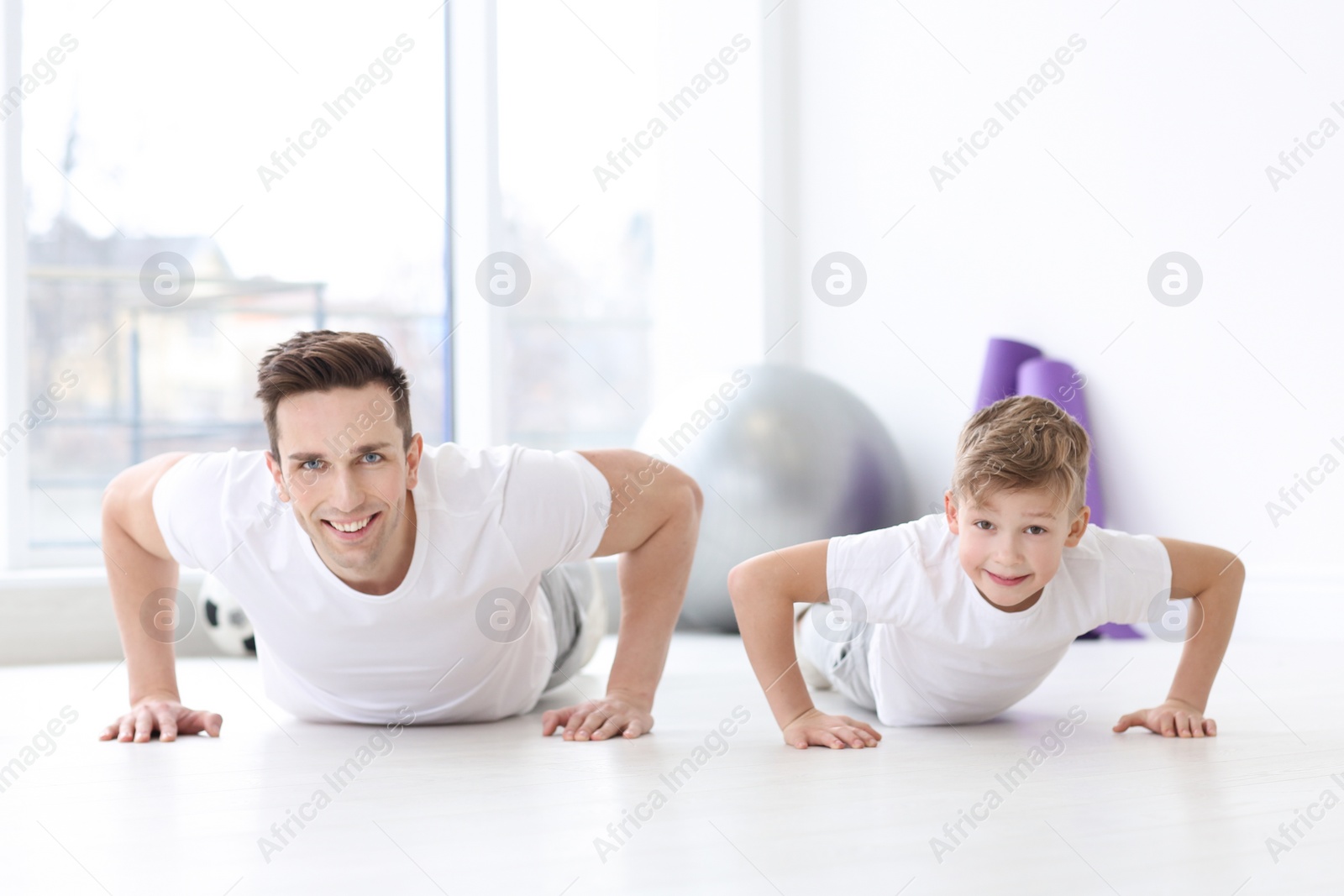Dad and his son training in gym Photo of Dad and his son training in gym