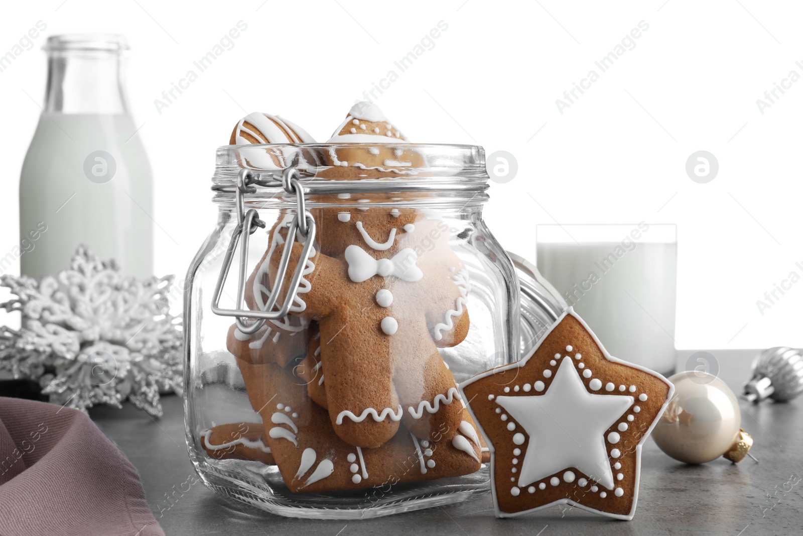 Tasty Christmas cookies and milk on grey table against white background, closeup Photo of Tasty Christmas cookies and milk on grey table against white background, closeup