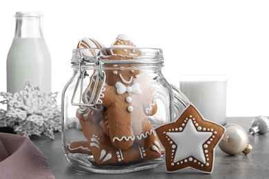 Tasty Christmas cookies and milk on grey table against white background, closeup Photo of Tasty Christmas cookies and milk on grey table against white background, closeup