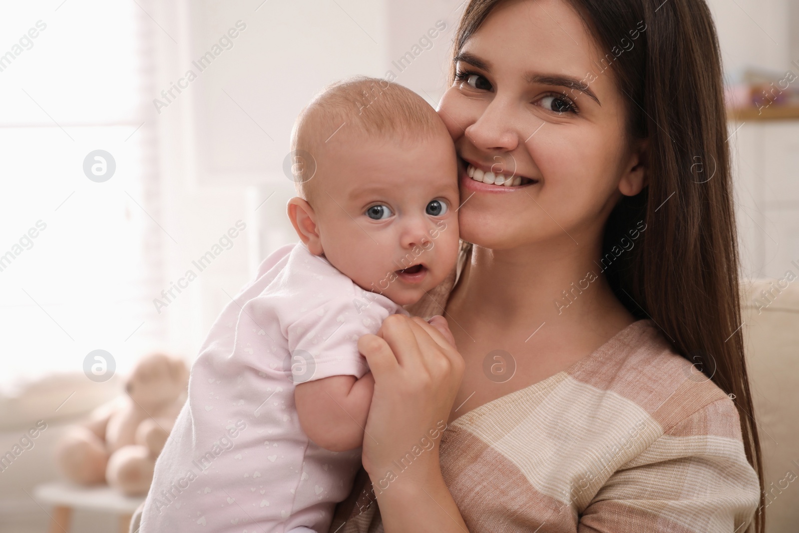 Happy young mother with her cute baby at home Photo of Happy young mother with her cute baby at home