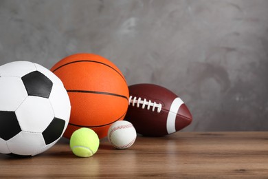 Set of different sport balls on wooden surface. Space for text Photo of Set of different sport balls on wooden surface. Space for text