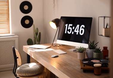 Room interior with comfortable workplace. Modern computer on wooden desk Photo of Room interior with comfortable workplace. Modern computer on wooden desk
