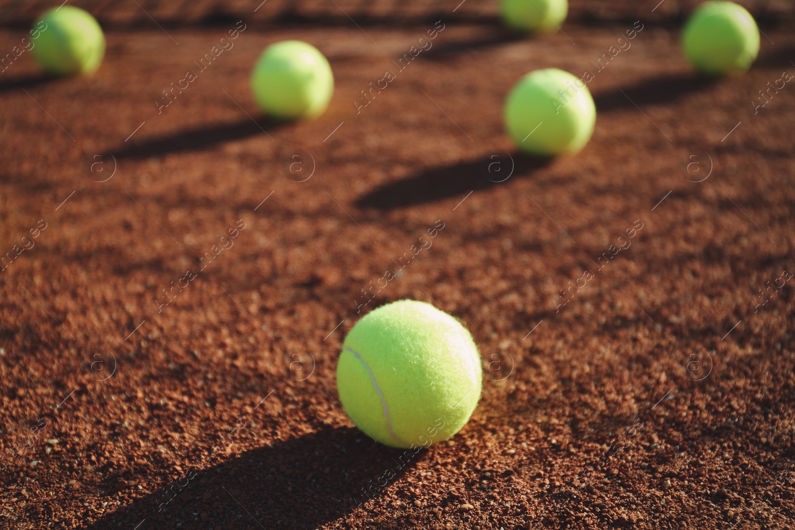 Bright yellow tennis ball on clay court Photo of Bright yellow tennis ball on clay court