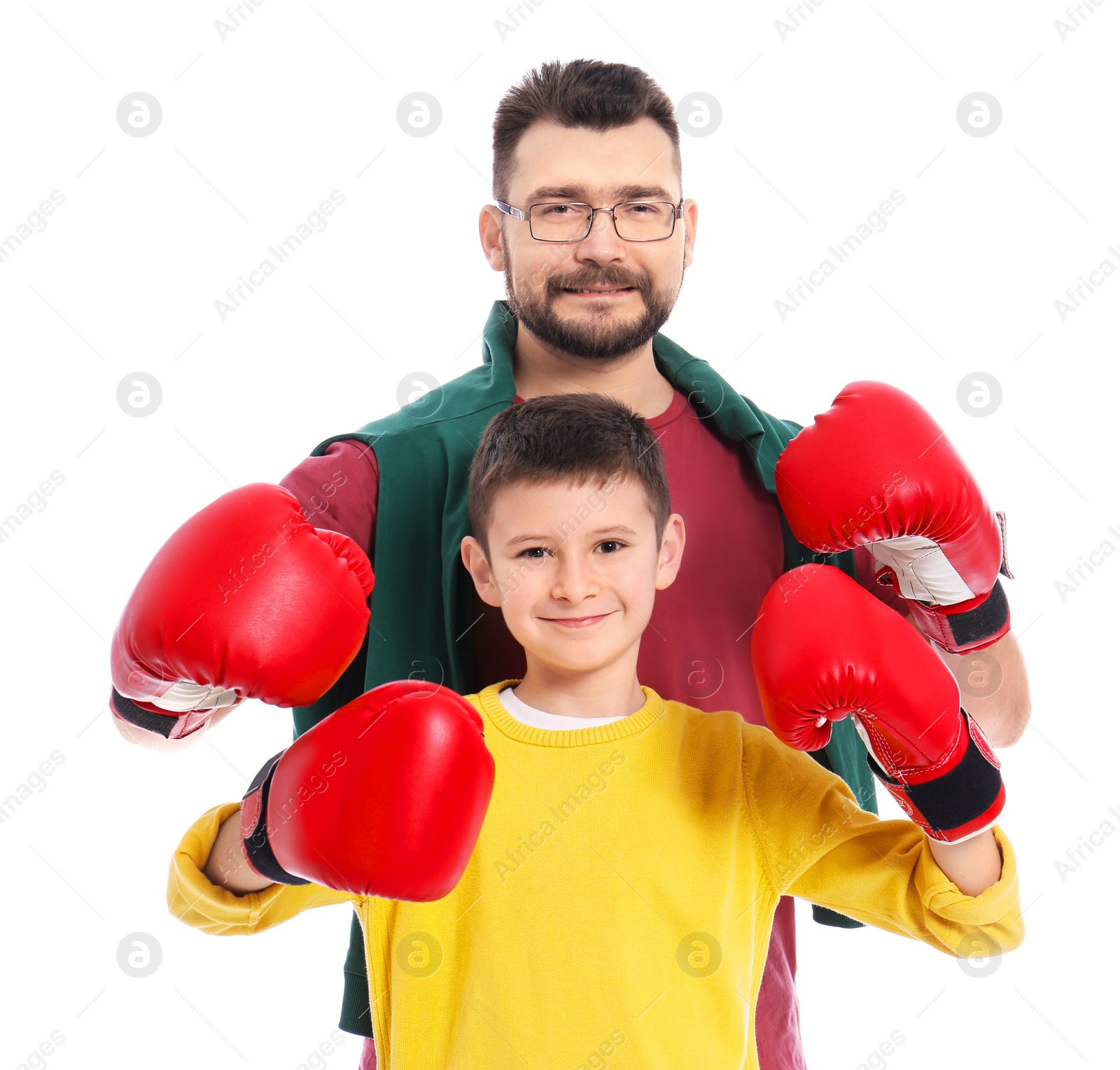 Little boy and his dad in boxing gloves on white background Photo of Little boy and his dad in boxing gloves on white background