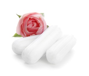 Tampons and beautiful rose on white background Photo of Tampons and beautiful rose on white background