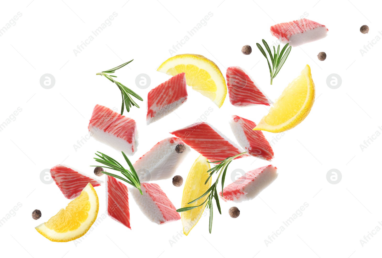 Cut fresh crab sticks, lemon, rosemary and allspice falling on white background Image of Cut fresh crab sticks, lemon, rosemary and allspice falling on white background