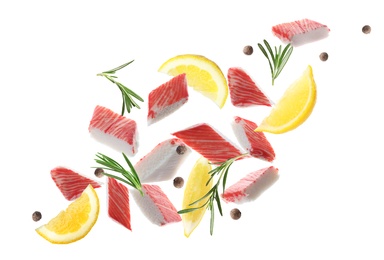 Cut fresh crab sticks, lemon, rosemary and allspice falling on white background Image of Cut fresh crab sticks, lemon, rosemary and allspice falling on white background