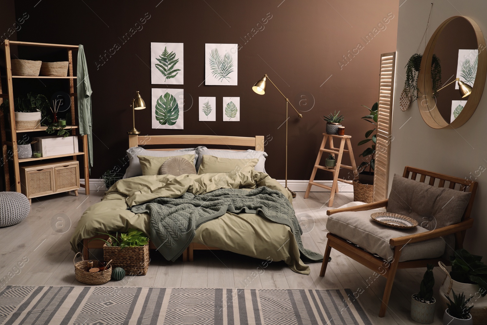 Stylish room interior with large bed and floral pictures Photo of Stylish room interior with large bed and floral pictures