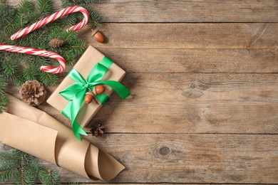 Flat lay composition with Christmas gift box on wooden table. Space for text Photo of Flat lay composition with Christmas gift box on wooden table. Space for text