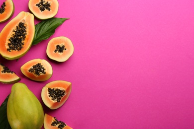 Fresh ripe papaya fruits with green leaves on purple background, flat lay. Space for text Photo of Fresh ripe papaya fruits with green leaves on purple background, flat lay. Space for text