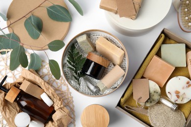 Photo of Cardboard boxes with eco friendly personal care products on white background, top view