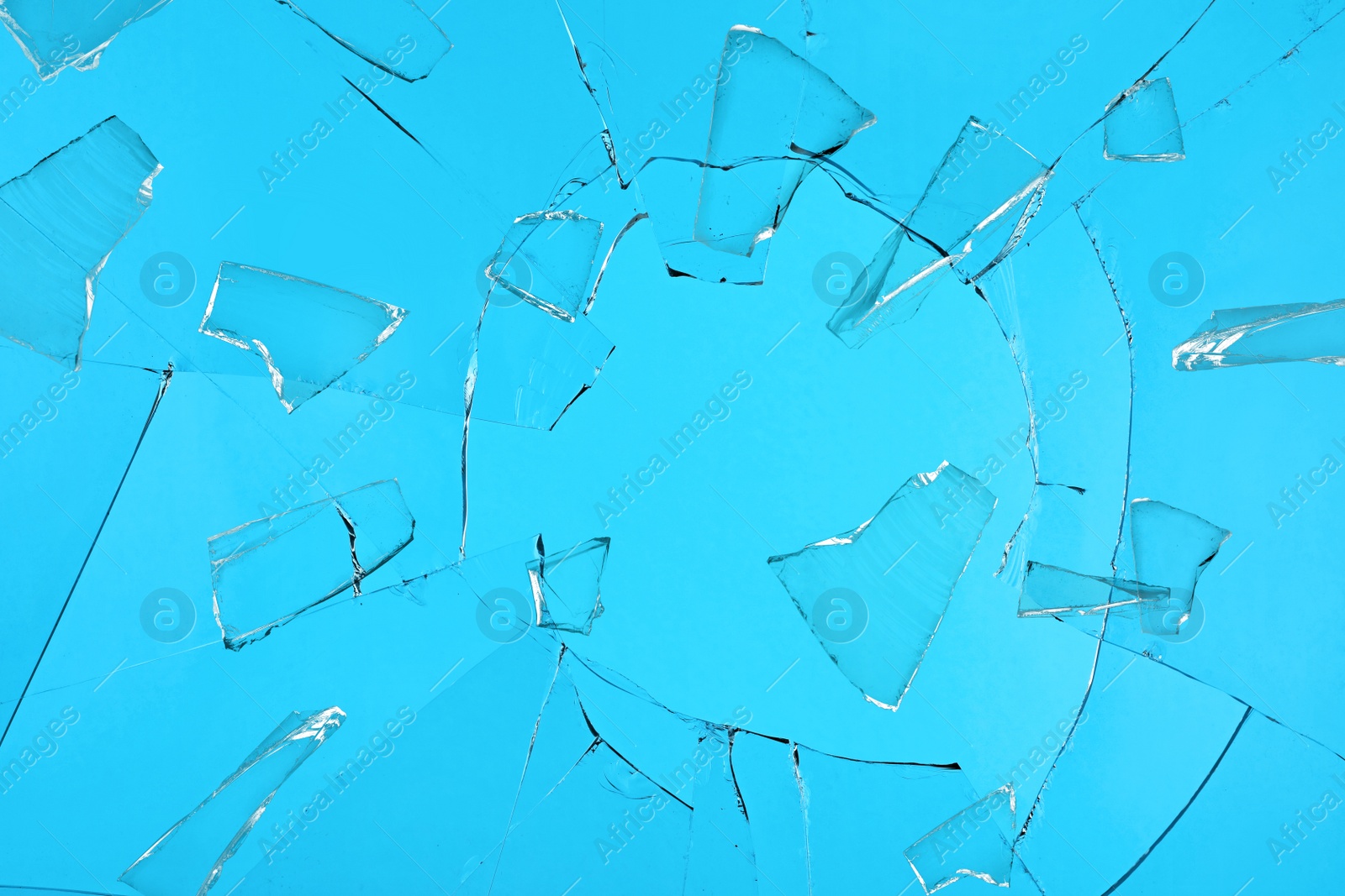 Broken glass with cracks on blue background Image of Broken glass with cracks on blue background