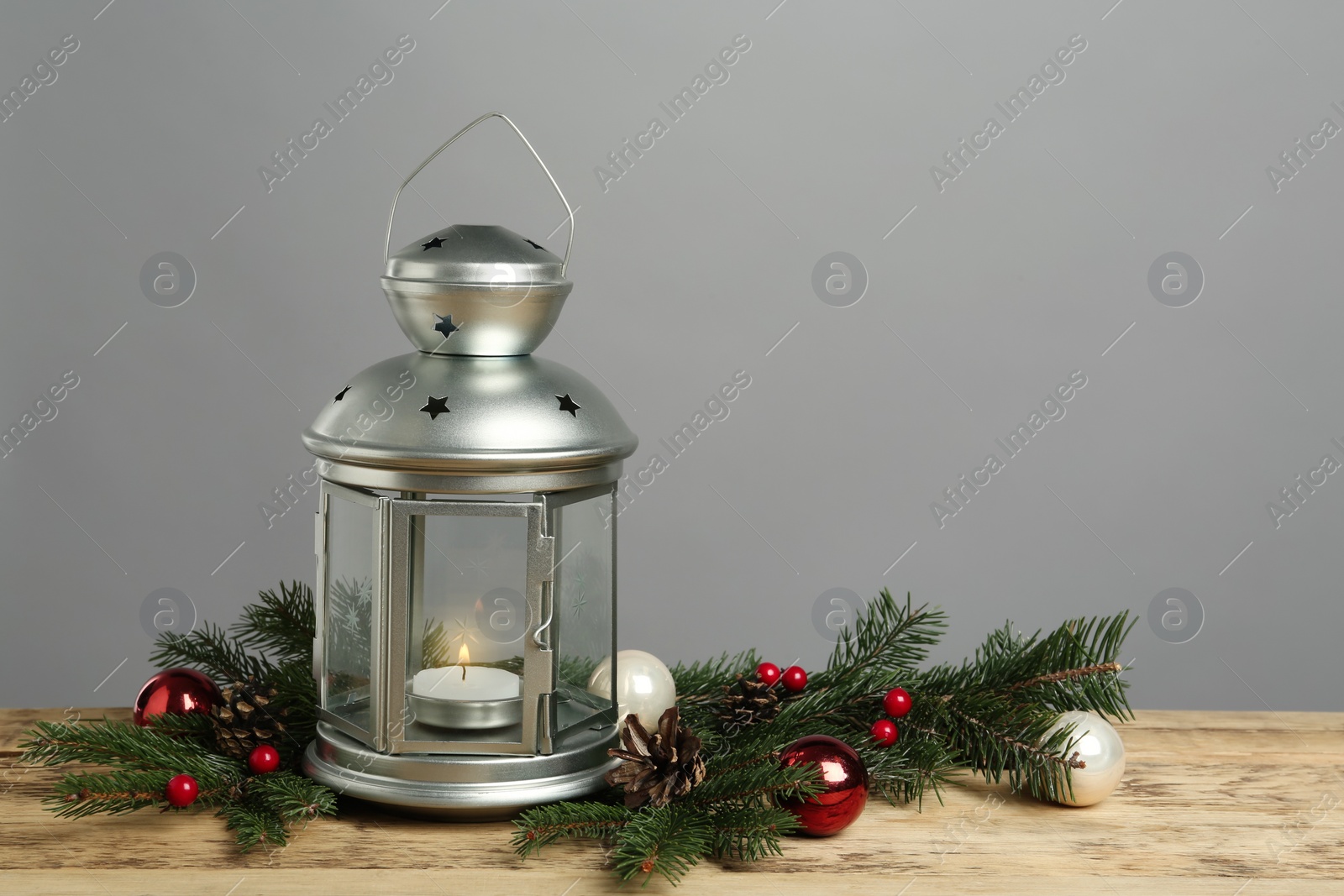 Lantern and Christmas decorations on grey background, space for text Photo of Lantern and Christmas decorations on grey background, space for text