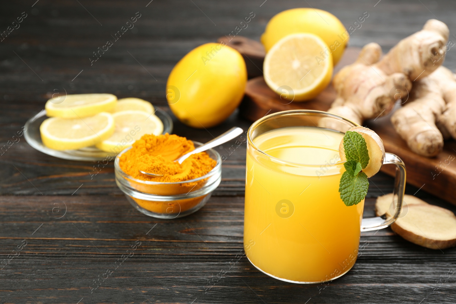 Immunity boosting drink and ingredients on dark wooden table. Space for text Photo of Immunity boosting drink and ingredients on dark wooden table. Space for text