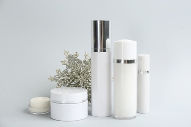 Beautiful composition with cosmetic products on light grey background. Winter care Photo of Beautiful composition with cosmetic products on light grey background. Winter care