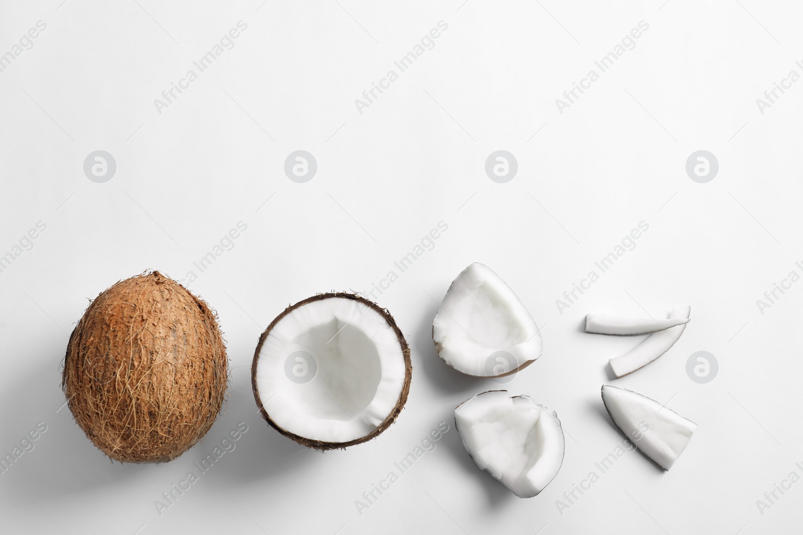 Pieces of coconut on white background, flat lay Photo of Pieces of coconut on white background, flat lay