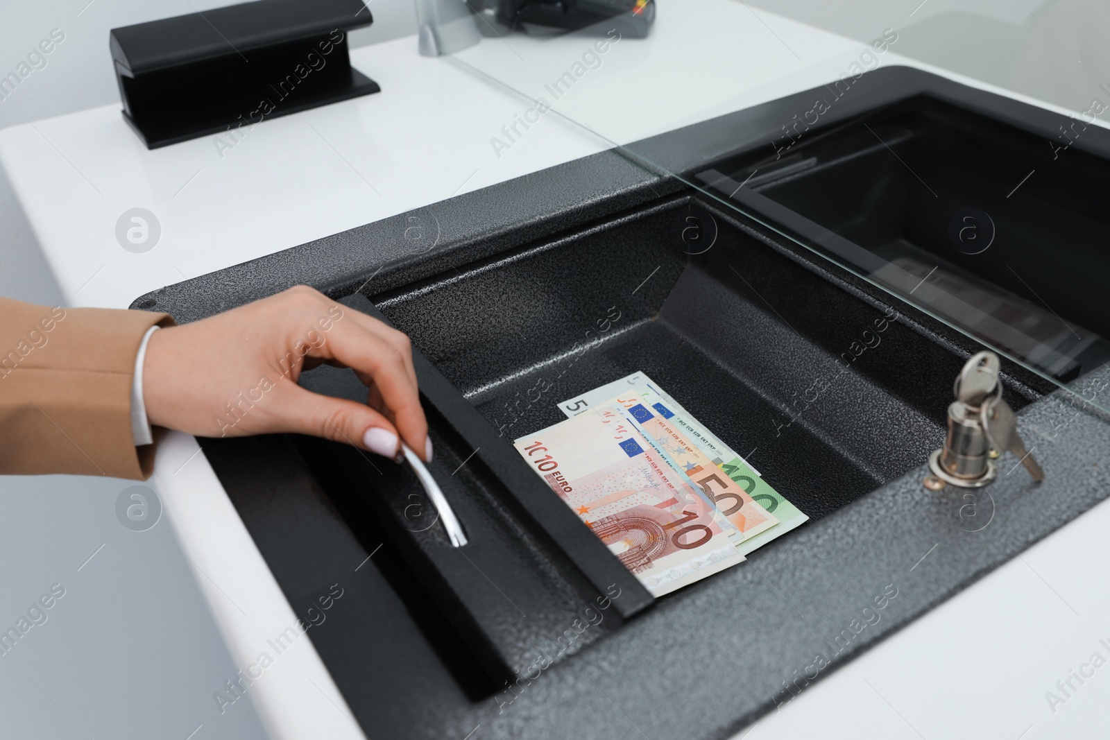 Cashier with money at bank, closeup. Currency exchange Photo of Cashier with money at bank, closeup. Currency exchange