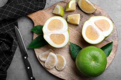 Photo of Flat lay composition with sweetie fruits on grey table