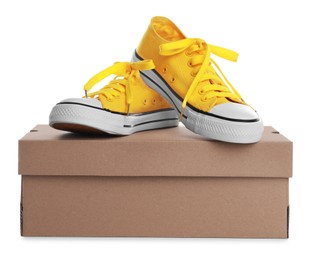 Pair of stylish sport shoes and cardboard box on white background Photo of Pair of stylish sport shoes and cardboard box on white background