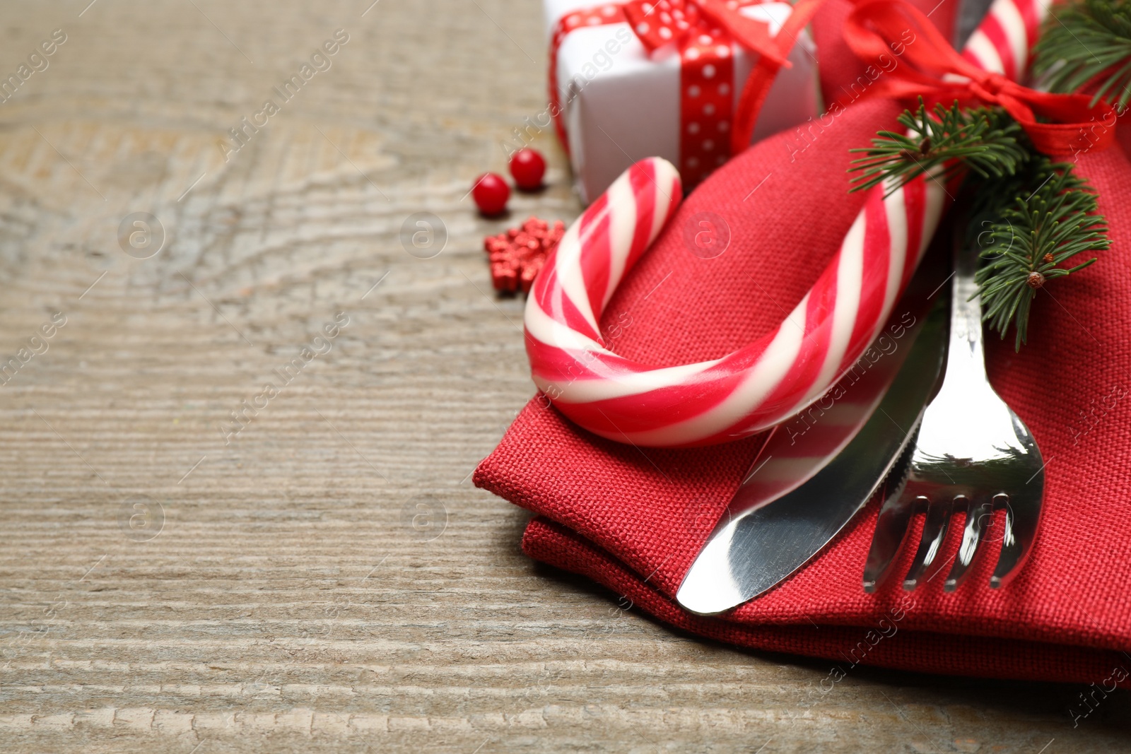 Cutlery set and festive decor on wooden table, closeup with space for text. Christmas celebration Photo of Cutlery set and festive decor on wooden table, closeup with space for text. Christmas celebration