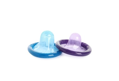 Unpacked colorful condoms on white background. Safe sex Photo of Unpacked colorful condoms on white background. Safe sex